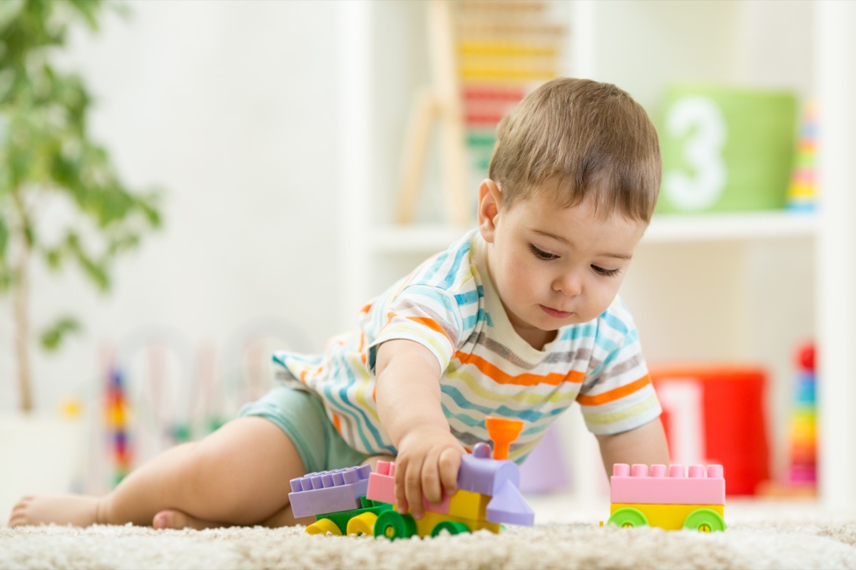 Wobblers baby room at Young Explorers Club creche, Dublin 15: a one-year-old playing with a toy train on the floor